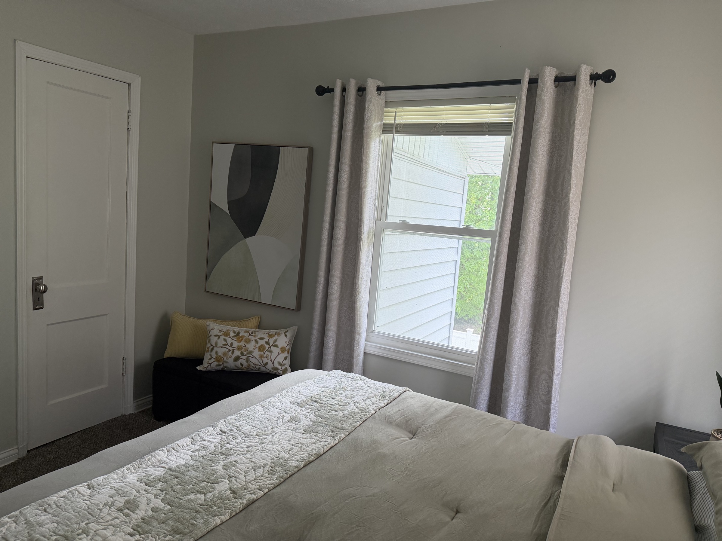Bedroom corner with soft seating and window