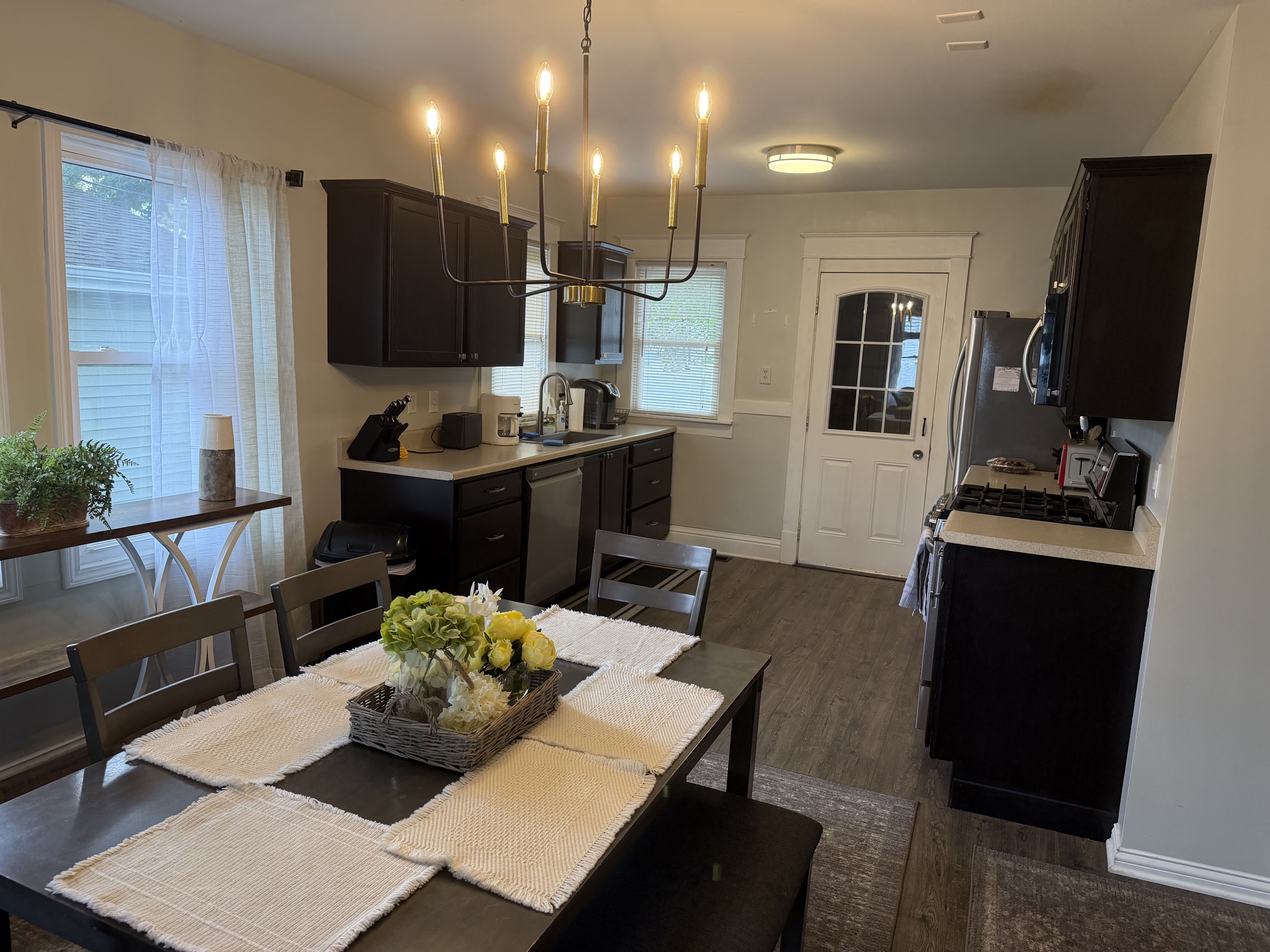 Kitchen and dining area with table and warm lighting