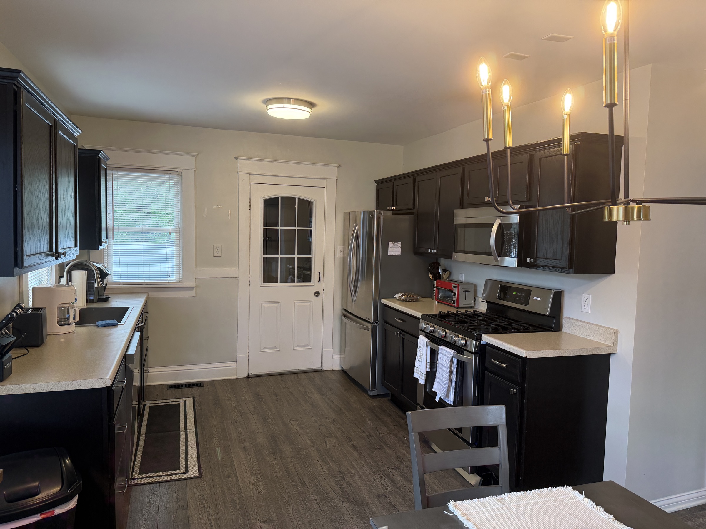 Kitchen with stainless appliances and dark cabinets