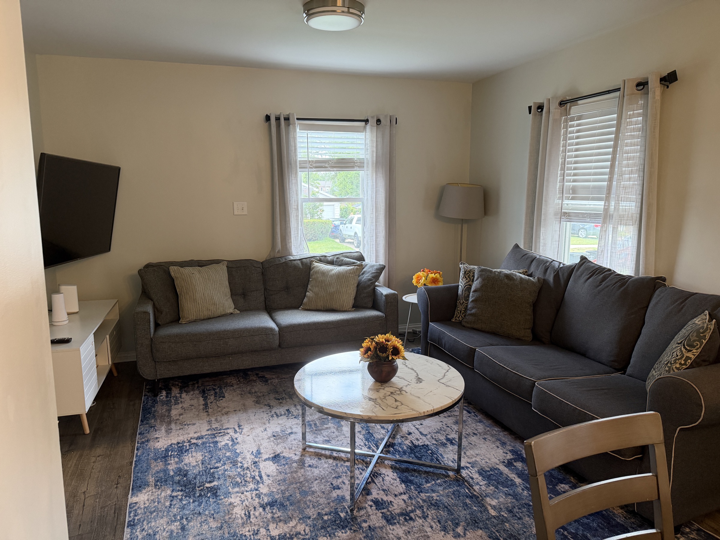 Living room with two sofas and front windows