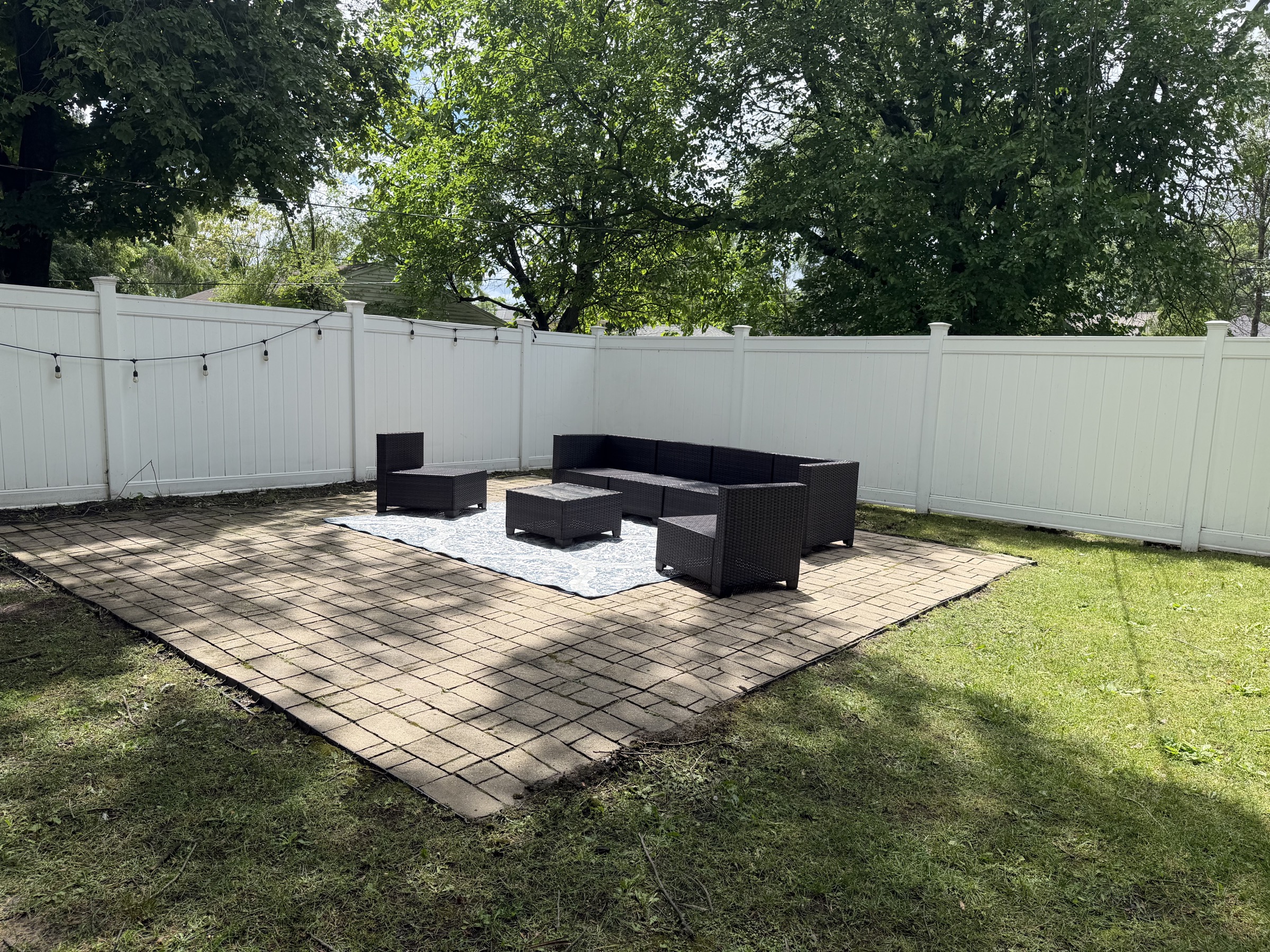 Fenced backyard patio with outdoor seating
